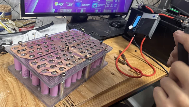 Full-size module with cells and busbars on the workbench.