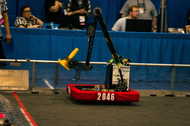 Team 2046 robot with the articulated arm during competition.
